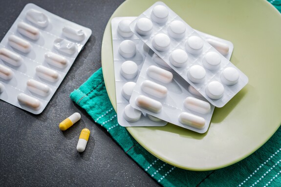 Antibiotika-Tabletten gegen Bronchitis liegen auf einem Tisch.